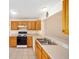 Bright kitchen with oak cabinets, stainless steel appliances, and tile flooring at 16847 Se 85Th Sapelo Ct, The Villages, FL 32162