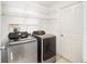 Laundry room with Samsung washer and dryer and ample shelving at 16847 Se 85Th Sapelo Ct, The Villages, FL 32162
