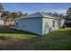 View of the home's back exterior and a small patio area at 1761 12Th St, Orange City, FL 32763