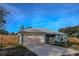 Newly built teal home with attached garage and landscaped yard at 1761 12Th St, Orange City, FL 32763