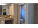 Bathroom with double sinks, granite countertops, and access to a toilet and shower at 1881 Sassparilla Way, The Villages, FL 32162