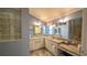 Bathroom with double vanities, granite countertops, and a walk-in shower at 1881 Sassparilla Way, The Villages, FL 32162