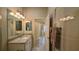Clean bathroom with granite vanity and shower at 1881 Sassparilla Way, The Villages, FL 32162