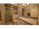 Bathroom with shower, toilet, and granite countertop at 1881 Sassparilla Way, The Villages, FL 32162