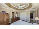 Spacious bedroom with wood furniture and ceiling fan at 1881 Sassparilla Way, The Villages, FL 32162