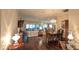 Spacious dining room with hardwood floors, chandelier, and views to living room at 1881 Sassparilla Way, The Villages, FL 32162