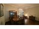 Formal dining room with hardwood floors, a stunning chandelier, and a beautiful china cabinet at 1881 Sassparilla Way, The Villages, FL 32162
