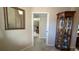 Entryway with mirror and corner cabinet, view into home at 1881 Sassparilla Way, The Villages, FL 32162