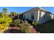 Landscaped side yard with lush green plants and grass at 1881 Sassparilla Way, The Villages, FL 32162