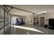 Bright garage with golf cart, storage shelving, and refrigerator at 1881 Sassparilla Way, The Villages, FL 32162