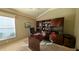 Home office with built-in wooden desk and shelving at 1881 Sassparilla Way, The Villages, FL 32162