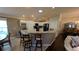 Modern kitchen boasts white cabinets, granite countertops, and a breakfast bar at 1881 Sassparilla Way, The Villages, FL 32162
