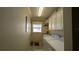 Bright laundry room with washer, dryer, and cabinets at 1881 Sassparilla Way, The Villages, FL 32162