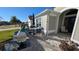 Front patio with seating area, welcome sign, and plants at 1881 Sassparilla Way, The Villages, FL 32162