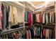 Well-organized walk-in closet with clothing and shelving at 1881 Sassparilla Way, The Villages, FL 32162