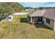 Spacious backyard with screened patio and large grassy area at 3219 Landing Vw, Tavares, FL 32778