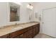 Double vanity bathroom with granite countertops and large mirrors at 3219 Landing Vw, Tavares, FL 32778