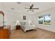 Spacious bedroom with hardwood floors and large window, ceiling fan at 3219 Landing Vw, Tavares, FL 32778