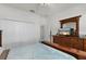 Bedroom with a wooden bed frame, dresser, and TV at 3219 Landing Vw, Tavares, FL 32778