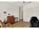 Bedroom with wooden desk and chair, and a view into the hallway at 3219 Landing Vw, Tavares, FL 32778