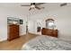 Main bedroom with hardwood floors, dresser, and ensuite bathroom access at 3219 Landing Vw, Tavares, FL 32778