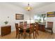 Bright dining room with wooden table and chairs, hardwood floors at 3219 Landing Vw, Tavares, FL 32778