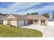 Two-car garage, front porch, and landscaped lawn at 3219 Landing Vw, Tavares, FL 32778