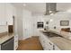 Modern kitchen with island, granite countertops and stainless steel appliances at 3219 Landing Vw, Tavares, FL 32778