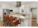 White kitchen with granite countertops and breakfast bar at 3219 Landing Vw, Tavares, FL 32778