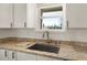 Kitchen sink and granite countertop with a view from the window at 3219 Landing Vw, Tavares, FL 32778
