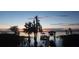 Sunset view of lakefront property with dock and seating at 3219 Landing Vw, Tavares, FL 32778