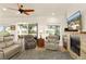 Spacious living room with fireplace and lake view at 3219 Landing Vw, Tavares, FL 32778