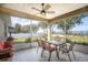 Relaxing screened porch with seating area and lake view at 3219 Landing Vw, Tavares, FL 32778