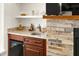 Built-in wet bar with granite countertop and mini-fridge at 3219 Landing Vw, Tavares, FL 32778