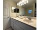 Double vanity bathroom with updated fixtures and a large mirror at 61 Fir Dr, Ocala, FL 34472