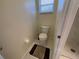 Simple toilet area with tile flooring and a small window at 61 Fir Dr, Ocala, FL 34472