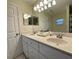 Double vanity bathroom with updated fixtures and a large mirror at 61 Fir Dr, Ocala, FL 34472