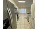 Open kitchen with white cabinets and granite countertops at 61 Fir Dr, Ocala, FL 34472