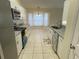 Open kitchen with white cabinets, granite counters, and stainless steel appliances at 61 Fir Dr, Ocala, FL 34472