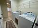 Convenient laundry room with washer, dryer, and shelving at 61 Fir Dr, Ocala, FL 34472