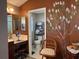Elegant bathroom with double vanity, walk-in shower, and decorative mural at 752 Maybank Loop, The Villages, FL 32162