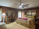Spacious Primary bedroom with large bed, sitting area, and plenty of natural light at 752 Maybank Loop, The Villages, FL 32162