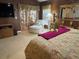 Bright Primary bedroom featuring a comfortable sitting area and access to a private patio at 752 Maybank Loop, The Villages, FL 32162
