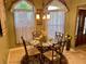 Charming dining area with a glass-top table and four chairs, perfect for intimate gatherings at 752 Maybank Loop, The Villages, FL 32162