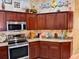 Sleek kitchen design with stainless steel appliances and granite countertops at 752 Maybank Loop, The Villages, FL 32162