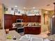 Well-equipped kitchen with modern appliances and rich wood cabinetry at 752 Maybank Loop, The Villages, FL 32162