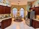 Kitchen boasts ample cabinetry, stainless steel appliances, and a breakfast nook at 752 Maybank Loop, The Villages, FL 32162
