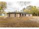 Brick house with a green roof and arched windows at 12359 Ne Highway 314, Silver Springs, FL 34488