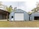 Large metal garage with roll-up door at 12359 Ne Highway 314, Silver Springs, FL 34488