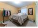 Bedroom with bed, clothing rack and window at 12359 Ne Highway 314, Silver Springs, FL 34488